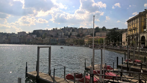 View of buildings in city against cloudy sky