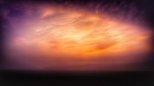 Scenic view of sea against romantic sky at sunset