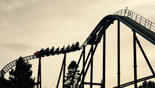 Low angle view of rollercoaster against sky