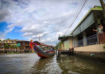 View of boats in canal along buildings