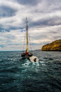 Sailboat in sea against sky