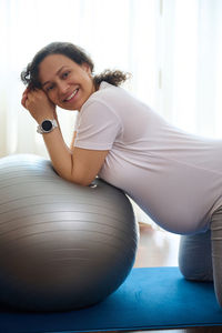 Young woman exercising in gym