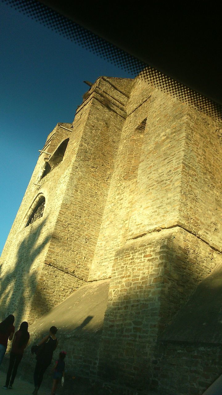 architecture, building exterior, built structure, low angle view, clear sky, blue, sky, building, tower, sunlight, window, history, outdoors, day, no people, church, shadow, wall - building feature, old, exterior