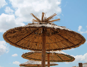 Low angle view of parasols against sky