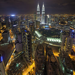 Aerial view of illuminated buildings in city at night