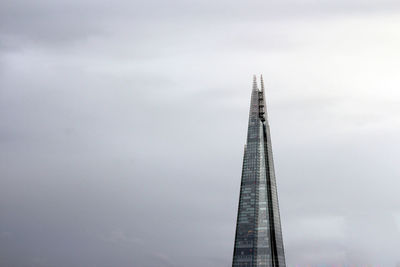 Low angle view of communications tower against sky