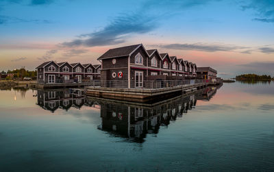 Pier over lake against sky during sunset