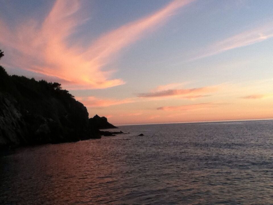 sea, water, horizon over water, sunset, scenics, tranquil scene, beauty in nature, tranquility, sky, orange color, nature, idyllic, waterfront, cloud - sky, rippled, cloud, outdoors, rock - object, rock formation, remote