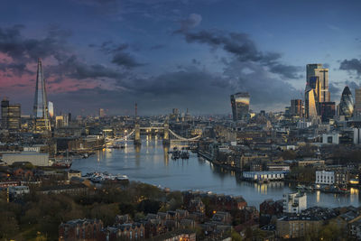 City by river against sky