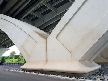 Low angle view of bridge amidst buildings in city