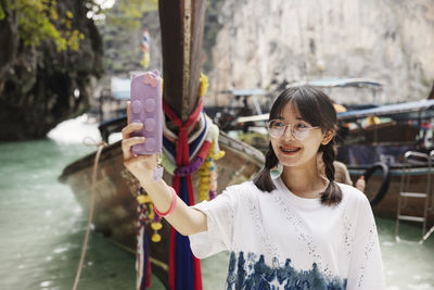 Teenage girl taking selfie in canyon