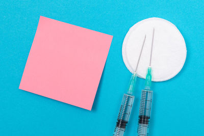 High angle view of multi colored paper on blue table