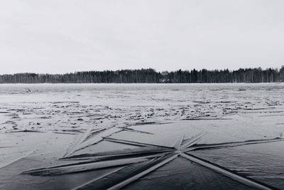 Scenic view of snowy field against sky during winter