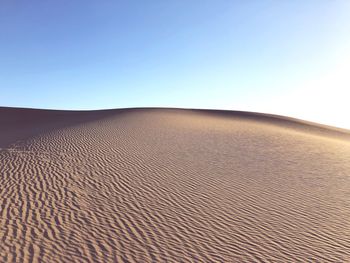 Scenic view of desert against clear sky