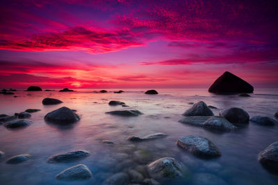 Scenic view of sea against romantic sky at sunset