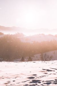 Scenic view of landscape against sky during winter