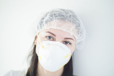 Close-up portrait of beautiful young woman over white background