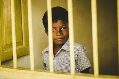 Portrait of boy standing in curtain