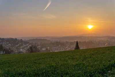 Scenic view of field against sky during sunset