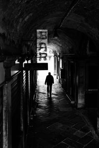 Rear view of man in tunnel