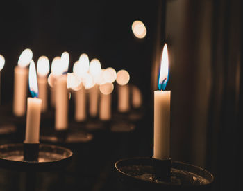 Close-up of illumiated candles in church