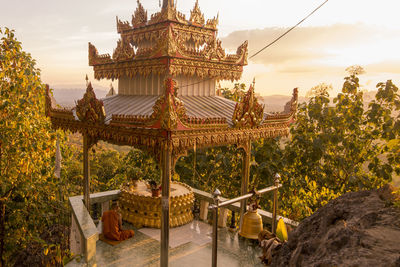 Traditional temple against sky during sunset