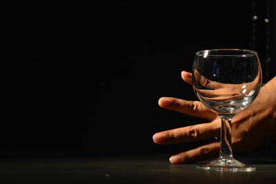 Close-up of beer glass against black background