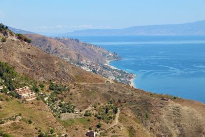 High angle view of sea and mountains against sky