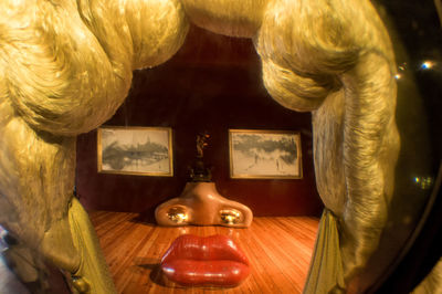 Close-up of illuminated lamp on table at home