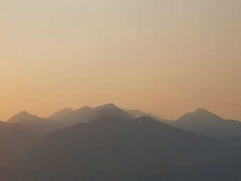 Scenic view of silhouette mountains against sky during sunset