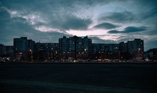 Illuminated buildings against sky at night