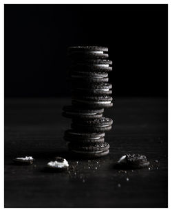 Close-up of stack on table against black background