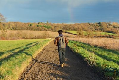 People walking on grassy field