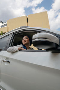 Woman smiling while sitting in car