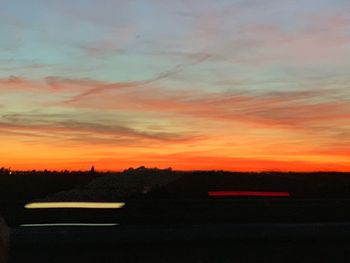 Scenic view of silhouette landscape against sky at sunset