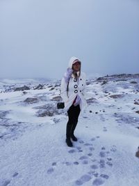 Full length of man standing in snow