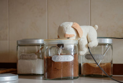 Close-up of stuffed toy on jar at table