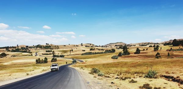 Road amidst landscape against sky