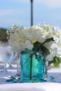 Close-up of white roses in vase on table