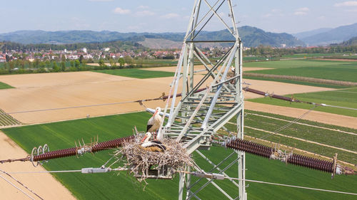 Metallic structure on field against sky