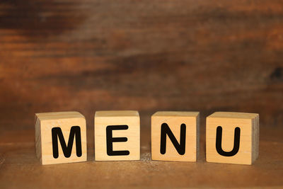 Close-up of information sign on table