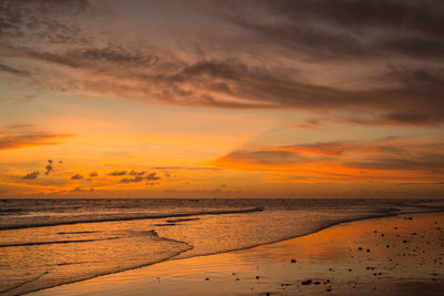 Scenic view of beach against sky during sunset