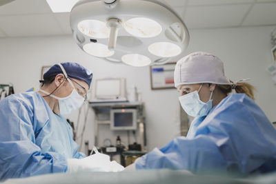 Doctors in uniforms preparing for operation in surgery