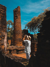 Man photographing old ruin
