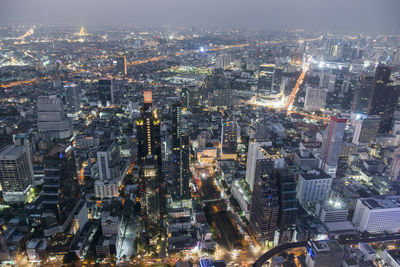 High angle view of illuminated modern buildings in city at night