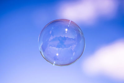 Close-up of crystal ball in blue water