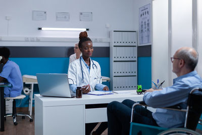 Female working talking with patient in clinic