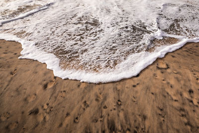 High angle view of surf on beach