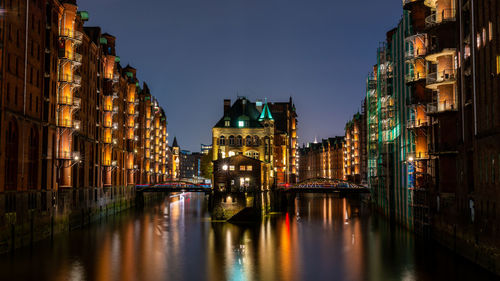 Illuminated buildings in city at night