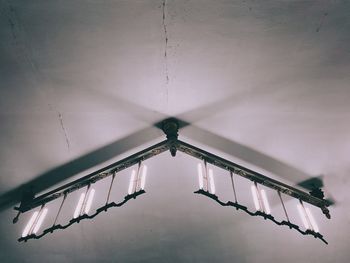 Low angle view of electric lamp hanging on ceiling